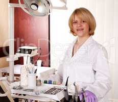 female dentist with equipment posing