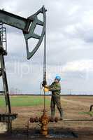 oil worker standing at pipeline