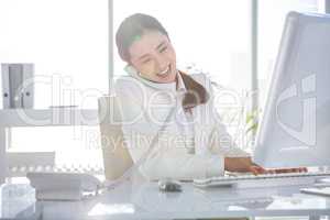 Smiling businesswoman using her computer