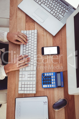 Cropped image of woman typing on keyboard