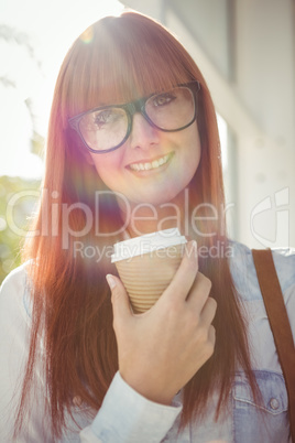 SMiling woman holding a cup of coffee