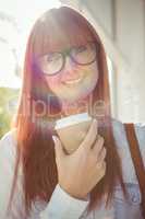 SMiling woman holding a cup of coffee