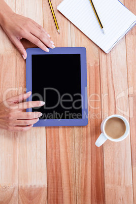 Overhead of feminine hands using tablet