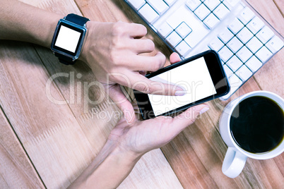 Feminine hands with smartwatch using smartphone