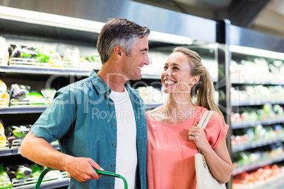 Smiling couple at the supermarket