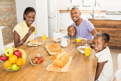 Casual happy family having breakfast