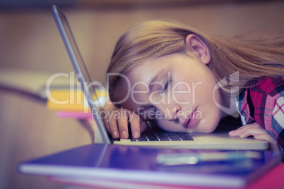 Blonde student sleeping on laptop