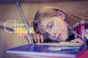 Blonde student sleeping on laptop