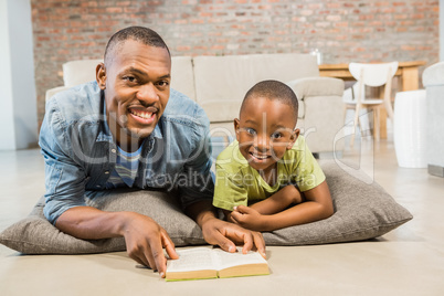 Father and son reading on the floor