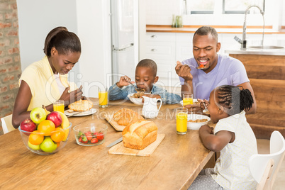 Casual happy family having breakfast