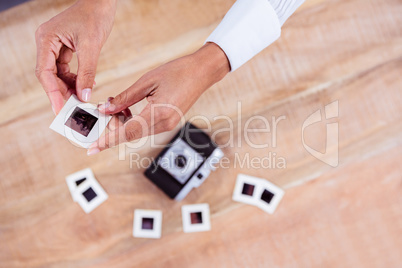 View of hands holding photo slides