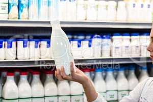 Beautiful woman holding milk bottle
