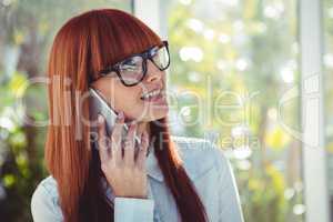 Smiling hipster woman on phone