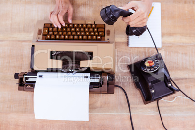 Above view of typewriter and old phone