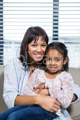 Happy mother embracing her daughter