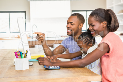 Smiling casual family on a computer Smiling casual family on a computer