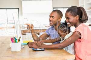 Smiling casual family on a computer