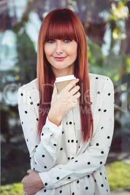 Attractive smiling hipster woman with take-away cup