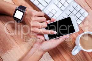Feminine hands with smartwatch using smartphone