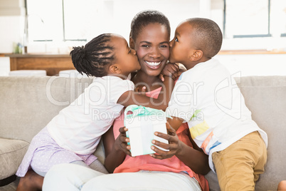 Children offering a gift to their mother