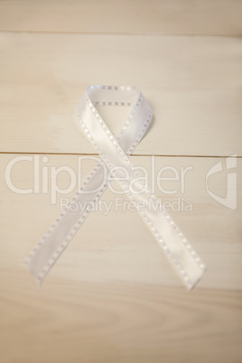 White ribbon on wooden desk