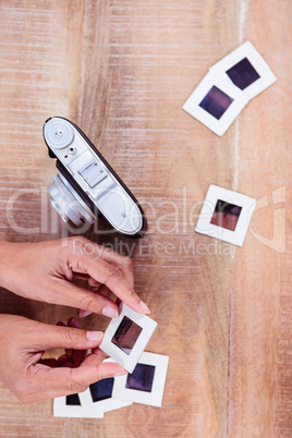 View of hands holding photo slides