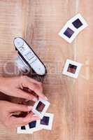 View of hands holding photo slides