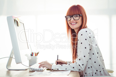 Attractive hipster woman using graphics tablet