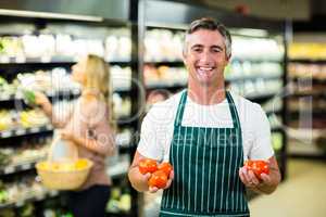 Smiling worker holding vegetables