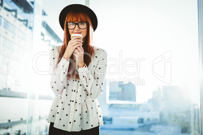 Smiling hipster woman drinking coffee