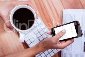 Businesswoman using her smartphone on desk