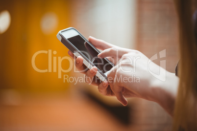 Standing student using smartphone