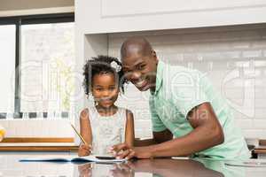 Father helping his daughter with homework