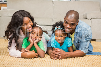 Happy family lying on the floor at home