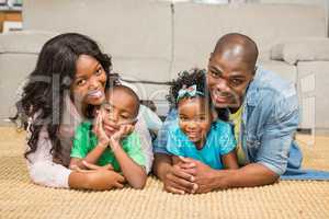 Happy family lying on the floor at home