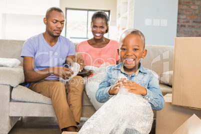 Family unwrapping things in new home