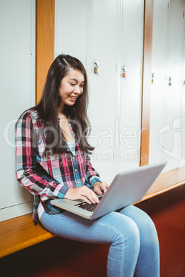 Smiling student sitting at the computer