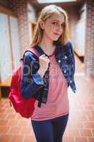 Pretty student with backpack looking at the camera