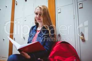 Focused student sitting and studying on notebook