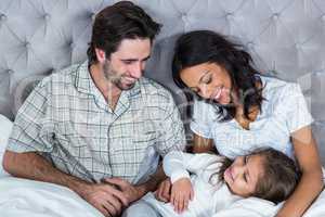 Happy family playing on bed