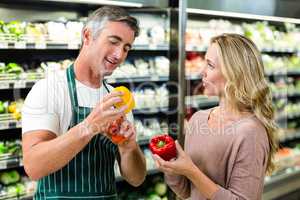 Smiling blonde woman buying a vegetables