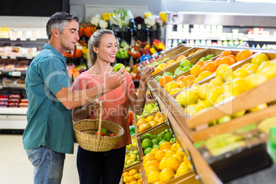 Happy couple holding apples