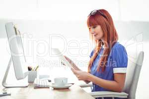 Smiling hipster woman looking at document