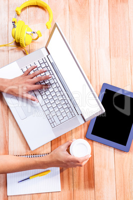 Womans hands typing on a laptop
