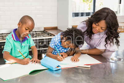 Children doing homework with their mother