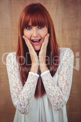 Surprised hipster woman posing face to the camera