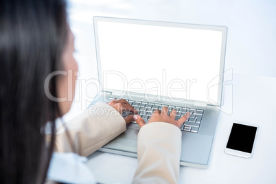 Rear view of businesswoman using laptop Rear view of businesswoman using laptop