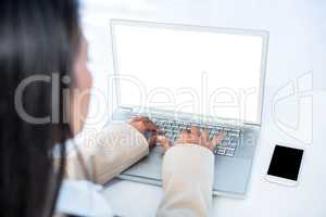 Rear view of businesswoman using laptop