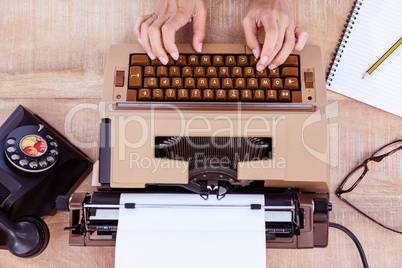 Above view of typewriter and old phone