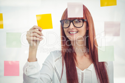 Attractive hipster woman looking at sticky notes